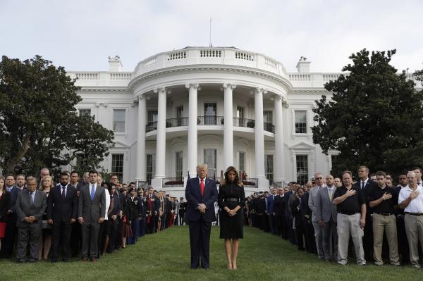 O presidente e a primeira-dama dos EUA, Donald e Melania Trump, participam de momento de silêncio em memória às vítimas dos atentados terroristas de 11 de Setembro, diante da Casa (Imagem:Evan Vucci/AP)