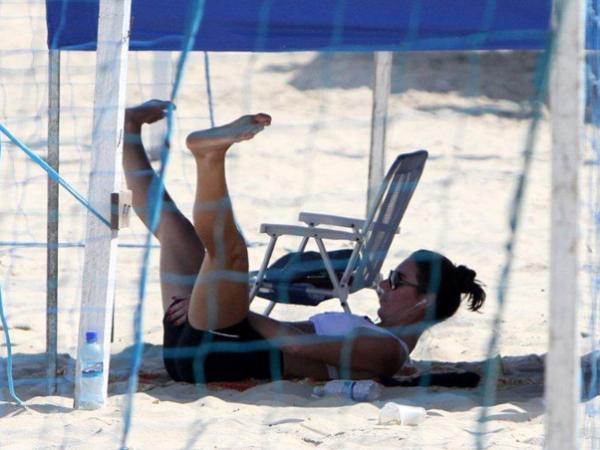 Glenda Koslowski se exercita à sombra de uma barraca de praia(Imagem:André Freitas/ AgNews)
