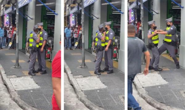 PM aponta a arma para o rosto do colega da corporação, que reage. Caso ocorreu no Centro de São Paulo e foi gravado por pedestres; imagens circulam nas redes sociais.(Imagem:Reprodução/ Redes sociais)