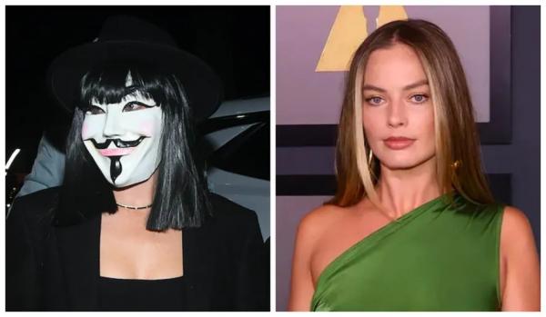 Margot Robbie com a máscara do protagonista de V de Vingança na festa de Halloween promovida por George Clooney e Rande Gerber.(Imagem:Getty Images)